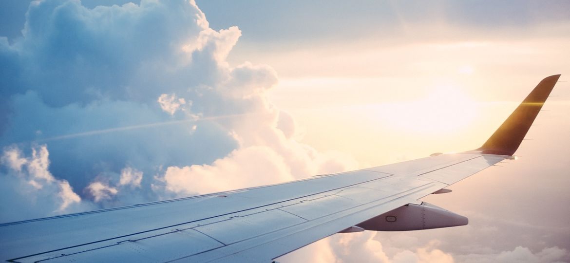 An image of a plane’s wing in front of clouds - Weight Loss Surgery Abroad - WeightLossRiga